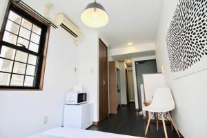 a room with a bed and a table and a chair at bHOTEL Pacifica - 30sec walk to PeacePark, Beautiful studio in Hiroshima