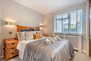 a bedroom with two beds and a window at Oakwood Bungalow Christchurch Sleeps 8 in Iford