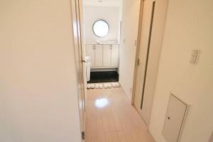 an empty hallway with a round window in a room at Luxes - 10 min Hiroshima Station & 2BR Up to 10p & 4 bikes in Hiroshima