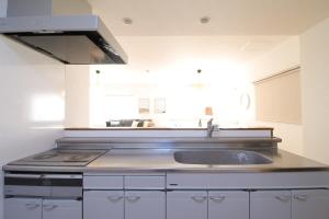 a kitchen with a sink and a stove at Marumasa by b hotel - Large 2BR Apt 10PPL near Peace Park 301 in Hiroshima