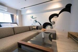 una sala de estar con un sofá y una mesa en Origaminn 301 by b hotel - 5 mins Peace Park, en Hiroshima 31 fotos más