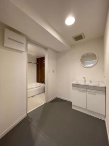 a bathroom with a sink and a bath tub at b hotel M's lea - Spacious Family apartment next to Peace Park in Hiroshima +17 photos