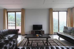 a living room with a couch and a coffee table at Vista Valle in Murree