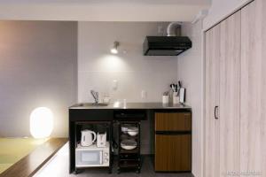 a kitchen with a sink and a counter top at bHOTEL Origaminn 303 - 5 mins PeacePark in Hiroshima