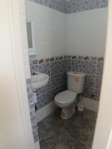 a bathroom with a toilet and a sink at Good View Buena vista1 Good View Buena Vista2 Good View Buena Vista3 in Asilah +9 photos