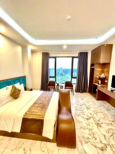 Cette chambre comprend un lit et une grande fenêtre. dans l'établissement Grand Ha Noi Hotel, à Hanoï