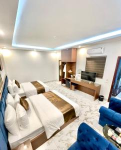 Cette chambre comprend deux lits et une télévision. dans l'établissement Grand Ha Noi Hotel, à Hanoï