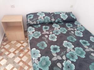 a bedroom with a bed with blue flowers on it at Good View Buena vista1 Good View Buena Vista2 Good View Buena Vista3 in Asilah