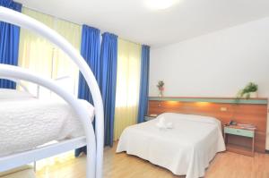 Voodi või voodid majutusasutuse Hotel Rex toas