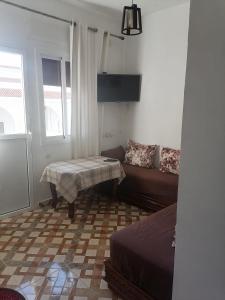 a living room with a couch and a table at Good View Buena vista1 Good View Buena Vista2 Good View Buena Vista3 in Asilah