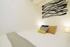 a white bedroom with a bed with two pillows at b hotel Ball Park - Apt 2mins to Baseball 5mins to Hiroshima Sta in Hiroshima +32 photos