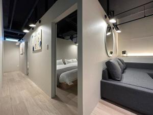 a hotel room with a bed and a mirror at bHOTEL New Small Hotel - Hondori shopping arcade in Hiroshima