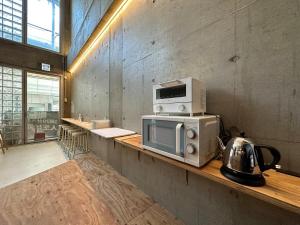 a microwave sitting on a counter in a room at bHOTEL New Small Hotel - Hondori shopping arcade in Hiroshima