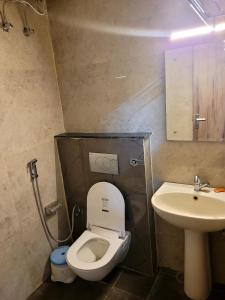 a bathroom with a toilet and a sink at Marks Farm in Alwar