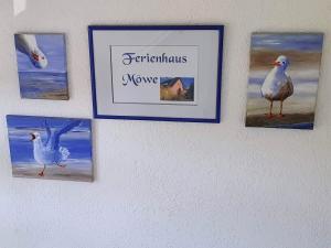 a group of pictures hanging on a wall at Ferienhaus Moewe in Hanshagen