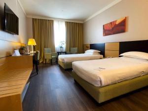 Postel nebo postele na pokoji v ubytování Best Western Plus Hotel Le Favaglie