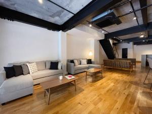 uma sala de estar com um sofá e uma mesa em bHOTEL Kaniwasou 101 1BR good for 8PPL in the scenic Island of Miyajima em Hatsukaichi