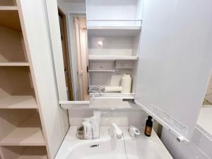 a bathroom with a sink and a mirror at bHOTEL Casaen - 1BR Apartment with beautiful City View Near Shopping District For 6Ppl in Hiroshima