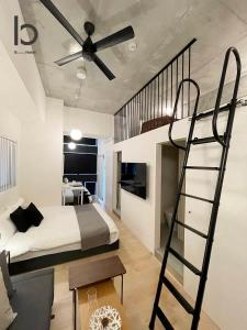 a bedroom with a loft bed and a ladder at b hotel Nekoyard - Loft Studio 5 Min Walk to Peace Park in Hiroshima
