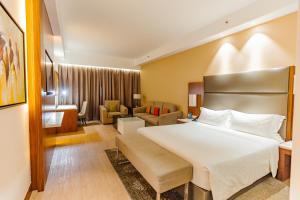 a hotel room with a bed and a living room at Crowne Plaza Nairobi Airport by IHG in Nairobi