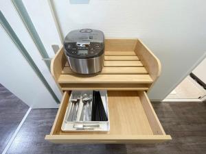 a kitchen with a mixer in a wooden drawer at Casaen by b hotel - Entire Apt for 6Ppl City Center in Hiroshima +14 photos