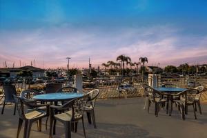 a patio with tables and chairs and a marina at Comfort Inn San Diego Airport At The Harbor in San Diego