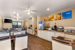 a restaurant with a kitchen with tables and chairs at Comfort Inn San Diego Airport At The Harbor in San Diego