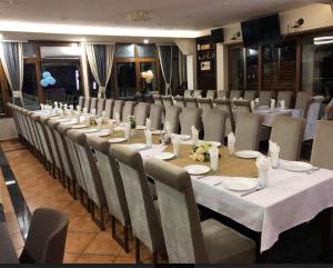 a long table and chairs in a room at AQUA RESORT in Plav