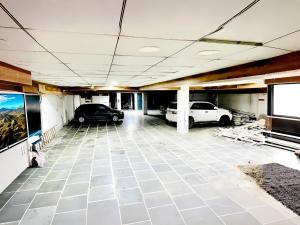 een garage met twee auto's erin geparkeerd bij The NDVL Hotel - Top Rated and Most Awarded Property in Haridwar in Haridwār