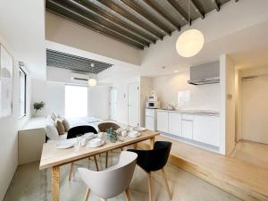 a kitchen and dining room with a table and chairs at bHOTEL Arts Dobashi - Studio Apt for 6 Ppl Near Peace Park in Hiroshima