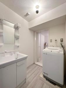 a bathroom with a sink and a washing machine at Mitao bld - Beautiful Apt for 10Ppl Very Near to Peace Park in Kami-nagarekawachō