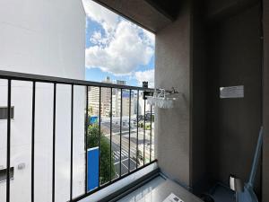 a bathroom with a balcony with a view of a street at Mitao bld - Beautiful Apt for 10Ppl Very Near to Peace Park in Kami-nagarekawachō