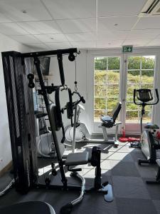 a gym with several tread machines in a room at La Bonbonniere - Sure Hotel Collection by Best Western in Dijon