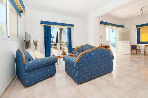 two blue chairs sitting in a living room at Villa Chloe in Ayia Napa