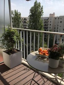 une plaque d'oranges sur une table sur un balcon dans l'établissement Appartement 70m2 terrasse vue jardin 10min Paris centre, à Levallois-Perret