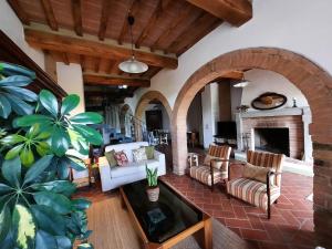 a living room with couches and a fireplace at La Capanna,piscina,vista,WiFi,in paese in San Giovanni dʼAsso