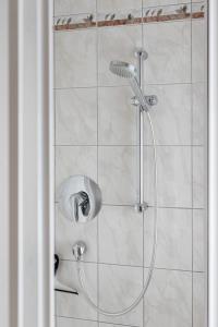a shower with a shower head in a bathroom at Grabmayrhof in Kremsmünster