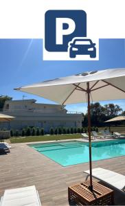 a pool with an umbrella and a table and chairs at SUNSEA - Enjoy Your Family in Capo Vaticano
