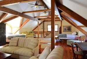 a living room with a vaulted ceiling with wooden beams at Berkshire Vacation Rentals: Peaceful Post and Beam Loft Sleeps 9 in New Marlborough
