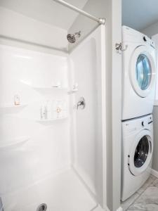 a white laundry room with a washer and dryer at Berkshire Vacation Rentals: Leicester Lake Front Home Come Relax in Leicester