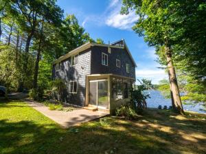 a tiny house on the shore of a lake at Berkshire Vacation Rentals: Leicester Lake Front Home Come Relax in Leicester