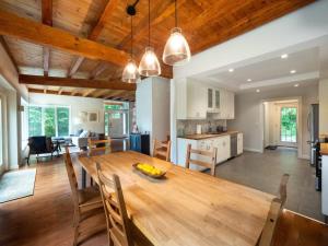 a kitchen and dining room with a wooden table and chairs at Berkshire Vacation Rentals: High End Berkshires Getaway in East Hillsdale