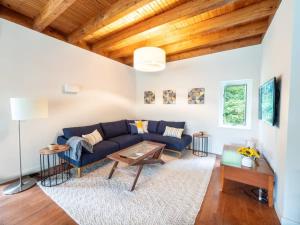 a living room with a blue couch and a table at Berkshire Vacation Rentals: High End Berkshires Getaway 