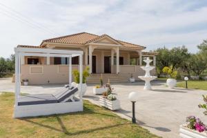 una casa con un porche y una fuente en el patio en Hidden Heaven Luxury Villa en Ambelókipoi