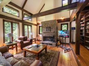 a living room with a fireplace and a tv at Berkshire Vacation Rentals: Pristine Home In Becket Woods in Becket