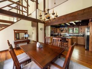 a dining room and kitchen with a wooden table and chairs at Berkshire Vacation Rentals: Pristine Home In Becket Woods in Becket