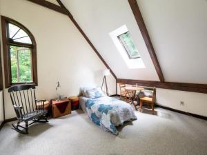 a bedroom with a bed and a table and chairs at Berkshire Vacation Rentals: Pristine Home In Becket Woods in Becket