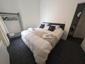 a bedroom with a large bed in a room at Seaview House - Flat 2 in Lowestoft