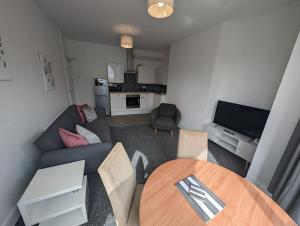 a living room with a couch and a table at Seaview House - Flat 2 in Lowestoft