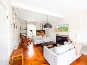 a living room with two white couches and a fireplace at Berkshire Vacation Rentals: Stunning 1860 Farmhouse Private Pond & Hot Tub in Taghkanic